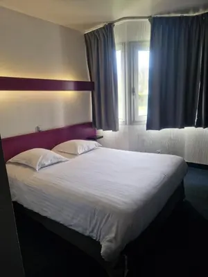Un ou plusieurs lits dans un hébergement de l'établissement Agape Hotel Niort- Bessines