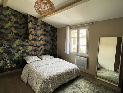 Un ou plusieurs lits dans un hébergement de l'établissement Maison cosy avec parking gratuit