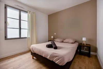 Un ou plusieurs lits dans un hébergement de l'établissement Villa avec Jacuzzi et Clim à Marsilly