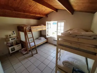 Un ou plusieurs lits dans un hébergement de l'établissement La Portbarquaise - maison front de mer
