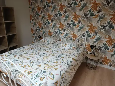 Un ou plusieurs lits dans un hébergement de l'établissement Charmante maison en pierres