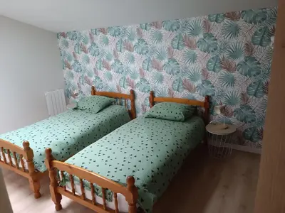 Un ou plusieurs lits dans un hébergement de l'établissement Charmante maison en pierres