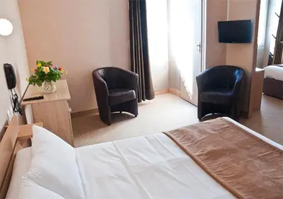 Un ou plusieurs lits dans un hébergement de l'établissement Hôtel des Pyrénées