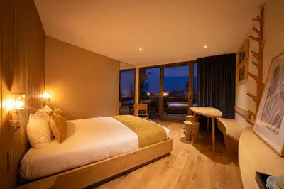 Un ou plusieurs lits dans un hébergement de l'établissement Hôtel Ecolodgee