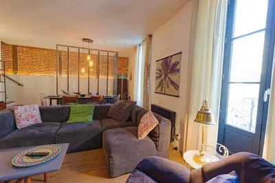 Coin salon dans l'établissement L'Olympe - triplex avec spa et rooftop Classé 4*