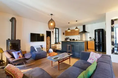 Coin salon dans l'établissement L'Olympe - triplex avec spa et rooftop Classé 4*