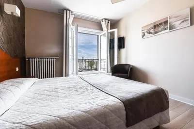 Un ou plusieurs lits dans un hébergement de l'établissement Hôtel Le Rupella