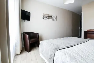 Un ou plusieurs lits dans un hébergement de l'établissement Hôtel Le Rupella
