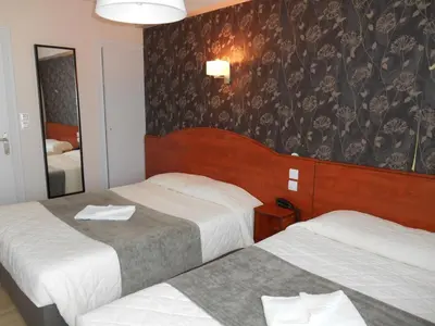 Un ou plusieurs lits dans un hébergement de l'établissement Hôtel Le Rupella