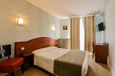 Un ou plusieurs lits dans un hébergement de l'établissement Hôtel Le Rupella