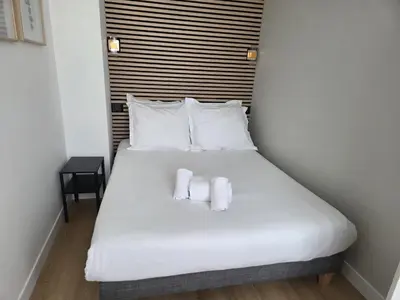 Un ou plusieurs lits dans un hébergement de l'établissement G2 Appartement Familial lumineux RDC centre Angouleme