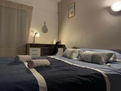 Un ou plusieurs lits dans un hébergement de l'établissement Appartement Les vagues dorées - Résidence Kiwi