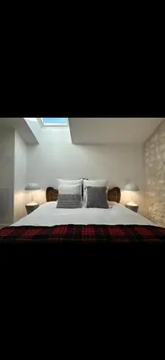 Un ou plusieurs lits dans un hébergement de l'établissement La Maison du Jardin