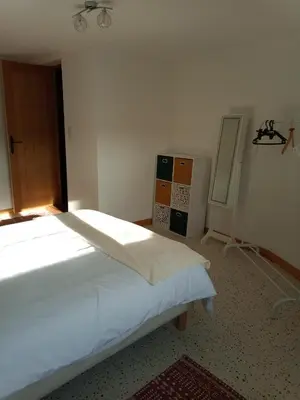 Un ou plusieurs lits dans un hébergement de l'établissement Au Coin Maison