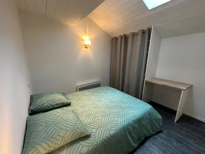 Un ou plusieurs lits dans un hébergement de l'établissement Duplex appartement