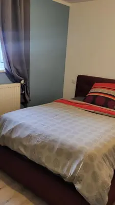 Un ou plusieurs lits dans un hébergement de l'établissement Chambre cosy spatieuse