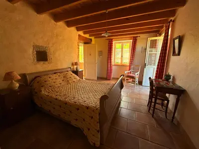 Un ou plusieurs lits dans un hébergement de l'établissement Chambre d'hôtes Les Bleuets