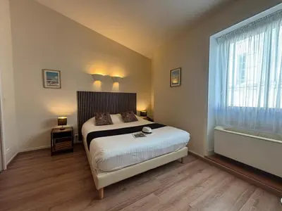 Un ou plusieurs lits dans un hébergement de l'établissement Les Apparts du Valois, Cognac Centre