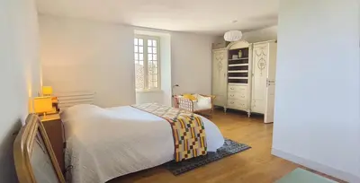 Un ou plusieurs lits dans un hébergement de l'établissement Gite 7 personnes à Montbron, Charente