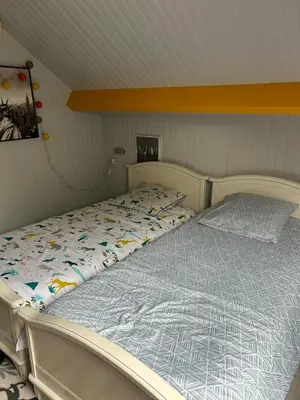 Un ou plusieurs lits dans un hébergement de l'établissement Chambre CHEZ L'HABITANT