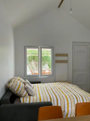 Un ou plusieurs lits dans un hébergement de l'établissement Cottage 50m de la plage