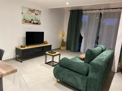 Télévision ou salle de divertissement dans l'établissement Duplex en pays mélusin