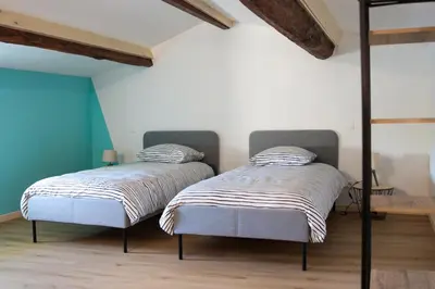 Un ou plusieurs lits dans un hébergement de l'établissement Gîte des forgerons