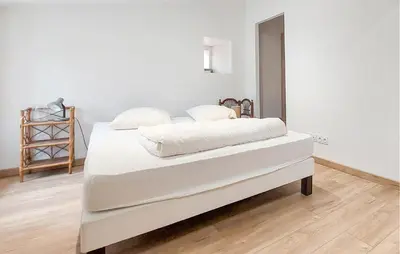 Un ou plusieurs lits dans un hébergement de l'établissement Charmante Maison Au Calme