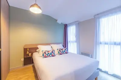 Un ou plusieurs lits dans un hébergement de l'établissement Appart'City Classic Angoulême Centre