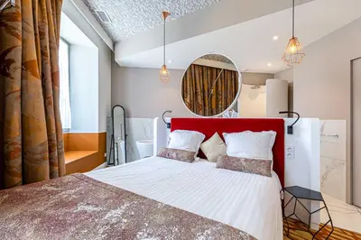 Un ou plusieurs lits dans un hébergement de l'établissement Hotel Le Saint Gelais