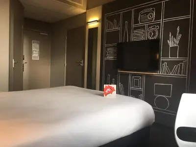 Un ou plusieurs lits dans un hébergement de l'établissement Ibis Niort Est Mendes France