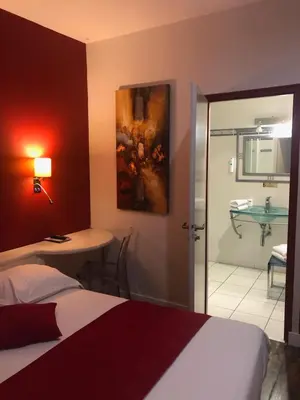 Un ou plusieurs lits dans un hébergement de l'établissement Cit'Hotel Europeen