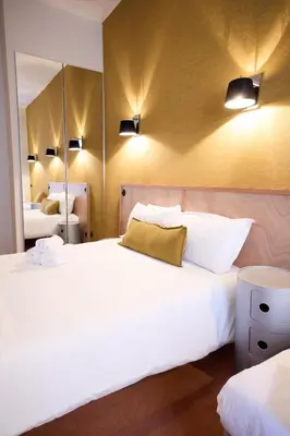 Un ou plusieurs lits dans un hébergement de l'établissement Hôtel Henri IV