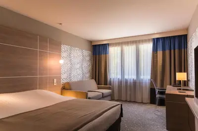 Un ou plusieurs lits dans un hébergement de l'établissement Logis LE RABELAIS Hôtel- Restaurant - SPA