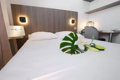 Un ou plusieurs lits dans un hébergement de l'établissement Hôtel Central