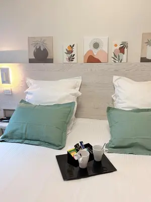 Un ou plusieurs lits dans un hébergement de l'établissement Hôtel La Fabrique