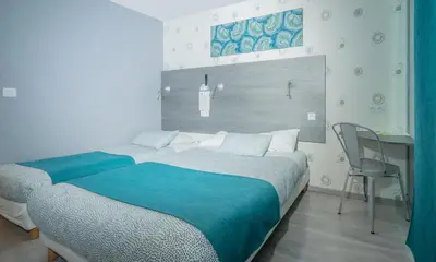 Un ou plusieurs lits dans un hébergement de l'établissement Hôtel Mac Bed