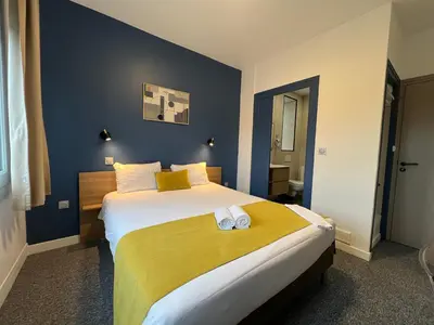Un ou plusieurs lits dans un hébergement de l'établissement Brit Hotel du Parc Niort Centre-Parking gratuit