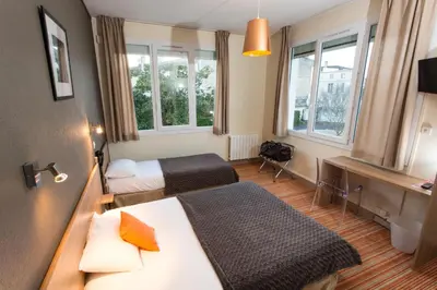 Un ou plusieurs lits dans un hébergement de l'établissement Brit Hotel du Parc Niort Centre-Parking gratuit