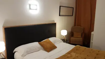Un ou plusieurs lits dans un hébergement de l'établissement hôtel restaurant Beau-rivage