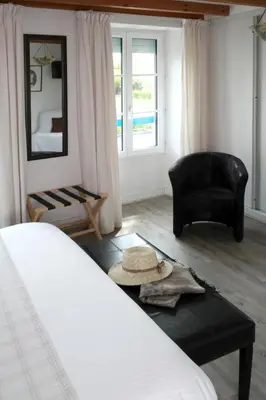 Un ou plusieurs lits dans un hébergement de l'établissement Hotel Au Marais