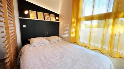 Un ou plusieurs lits dans un hébergement de l'établissement Futurostudio - Appart Hotel PACMAN - Futuroscope - Poitiers