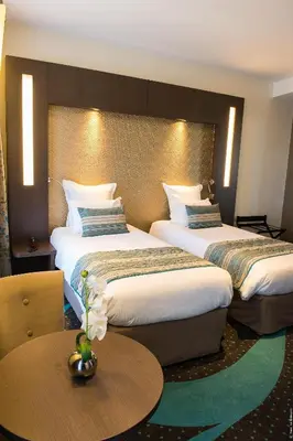 Un ou plusieurs lits dans un hébergement de l'établissement Hôtel François Premier Cognac Centre