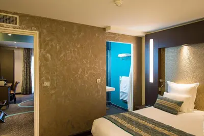 Un ou plusieurs lits dans un hébergement de l'établissement Hôtel François Premier Cognac Centre