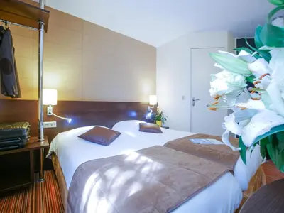 Un ou plusieurs lits dans un hébergement de l'établissement Hôtel Inn Design & Restaurant Poitiers