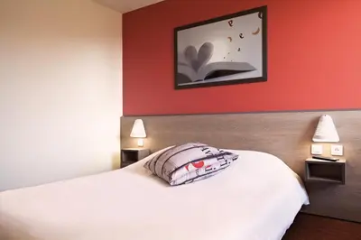 Un ou plusieurs lits dans un hébergement de l'établissement Ace Hotel Poitiers