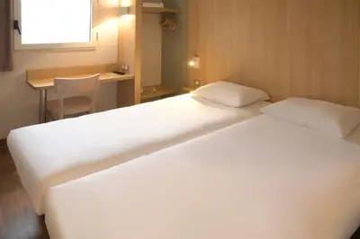 Un ou plusieurs lits dans un hébergement de l'établissement B&B HOTEL Angoulême