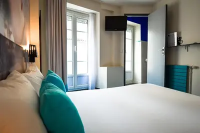 Un ou plusieurs lits dans un hébergement de l'établissement Hôtel Le Bord'O Vieux Port