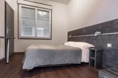 Un ou plusieurs lits dans un hébergement de l'établissement Hôtel de la Gare