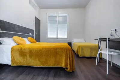 Un ou plusieurs lits dans un hébergement de l'établissement Hôtel de la Gare